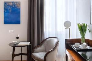 a living room with a table and a chair and a window at Relais Rione Ponte in Rome