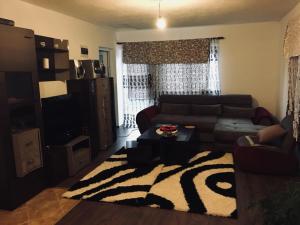 a living room with a couch and a table at Apartmani ,,Bato,, in Sjenica
