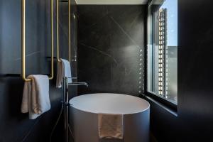 a bathroom with a white sink and a mirror at MaisonMe Boutique Hotel in Bardolino