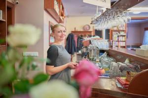a woman standing behind the counter of a store at Francis SPA HOTEL in Františkovy Lázně
