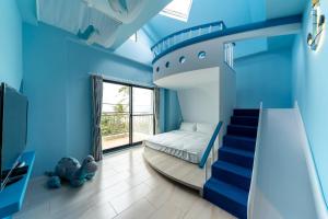 Ein Bett oder Betten in einem Zimmer der Unterkunft 墾丁宜庭海景親子民宿