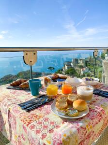 a table with breakfast food on a table with a view at Hotel Bonadies in Ravello