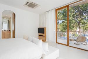 SALA Samui Chaweng Beach Resort客房内的一张或多张床位
