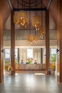 a lobby with chairs and chandeliers in a building at Hard Rock Hotel Desaru Coast in Desaru