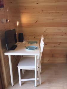 a white table with a chair and a computer on it at Earls View Pod in Carna