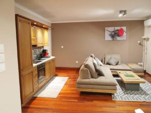 a living room with a couch and a table at Ideally Situated Corfu Old Town Apartment in Corfu