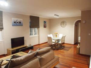 a living room with a couch and a table at Ideally Situated Corfu Old Town Apartment in Corfu Town