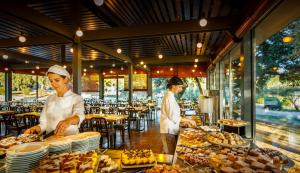 two chefs preparing food in a restaurant at Maistra Select Amarin Resort in Rovinj