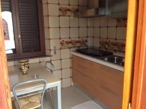 a small kitchen with a table and a sink at Orlando Vacanze Camere in Erice