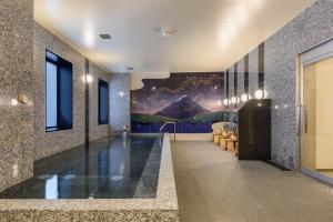 a hallway with a swimming pool in a building at hotel MONday Premium TOYOSU in Tokyo