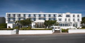 a large white building on the side of a street at Majestic Hotel in Tramore