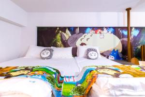 Postelja oz. postelje v sobi nastanitve 松楓親子民宿Songfeng Family B&B