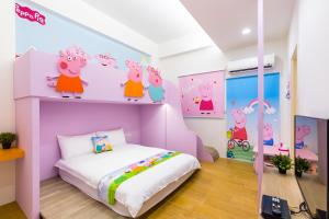 Postelja oz. postelje v sobi nastanitve 松楓親子民宿Songfeng Family B&B