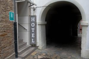 an entrance to a tunnel with a sign that says exit at Hotel Arco Navia in Navia