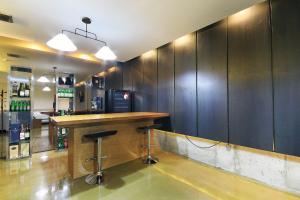 a kitchen with a refrigerator and a counter top at H Drive Hotel in Iksan