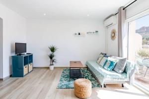 a living room with a couch and a tv at La Cassidaine in Cassis