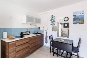 a kitchen with a table and a dining room at La Cassidaine in Cassis +24 photos