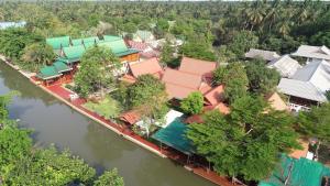 an aerial view of a village next to a river at บ้านกรนรา Baan Kornnara in Amphawa