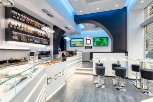 un ristorante con bar con sgabelli di THE ONE Boutique Hotel & SPA Rome a Roma