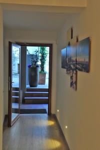 a hallway with a door with a potted plant at Bella Vacanza Limone in Limone sul Garda