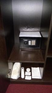 a small room with a microwave on a shelf at BeSt Hotel and Restaurant complex in Dunaivtsi