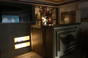 a bar with a clock and lights on the wall at Hotel Samrajya Pvt. Ltd. in Kathmandu