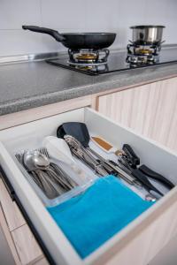 a drawer in a kitchen with utensils in it at DaMen Homestay @SubangHomeStay in Subang Jaya