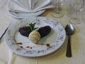 a plate of food with ice cream on a table at Hôtel Restaurant La Manse in Dornecy