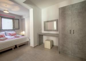 a bedroom with a bed and a mirror at Ithaka Zante City Villa in Zakynthos Town