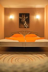 a bed in a bedroom with a picture of a giraffe at Kiev Central Apartment in Kyiv