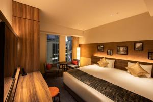 Postel nebo postele na pokoji v ubytování karaksa hotel premier Tokyo Ginza