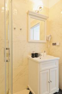 uma casa de banho com um lavatório branco e um chuveiro em Sun&Sport Apartament PARZENICA w super lokalizacji niedaleko wyciagu em Szczyrk