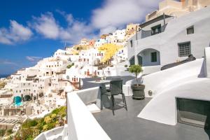 a view of the side of a hill with white buildings at Theodora Suites in Oia