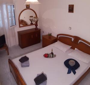 a bedroom with a bed with a bottle of beer on it at Tsina’s apartments in Ágios Nikólaos
