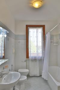 a bathroom with a sink and a toilet and a shower at Lago Trasimeno - Venere in Borghetto +7 photos