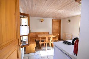 a kitchen with a table and a dining room at Les Hortensias in Riquewihr +11 photos