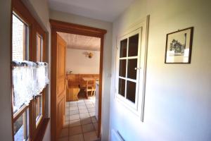 a hallway leading to a dining room with a table at Les Hortensias in Riquewihr