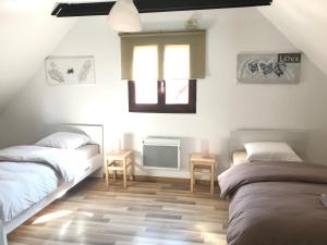 Postel nebo postele na pokoji v ubytování Aux deux hirondelles
