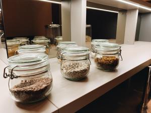 a counter with jars filled with different types of nuts at Hotel Mediteran in Zadar