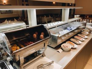 a buffet line with eggs and other food items at Hotel Mediteran in Zadar