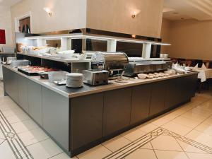 a large kitchen with a buffet of food at Hotel Mediteran in Zadar