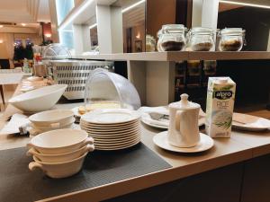 a kitchen counter with plates and dishes on it at Hotel Mediteran in Zadar