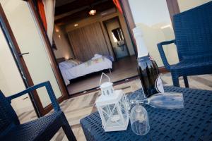 a bottle of wine sitting on a table with two chairs at Soleil B&B Gozo in Għarb