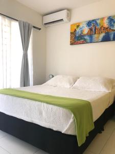 Postel nebo postele na pokoji v ubytování Hotel Balcones de Bocagrande