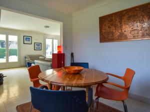 a dining room with a wooden table and chairs at Peaceful holiday home near the beach in Pénestin