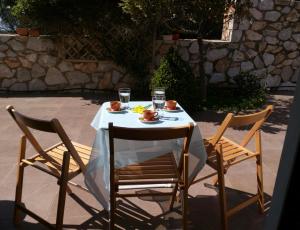 a table with two chairs and a table with drinks on it at Belle Hélène in Marathon