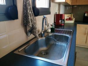 a kitchen sink with a dish drying rack in it at Belle Hélène in Marathon +58 photos