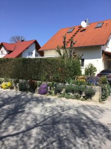 a house with a fence and a garden with flowers at Haus Schumacher in Uhldingen-Mühlhofen