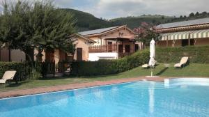 a swimming pool in front of a house at Il Borgo Dell'Ulivo in Trevi