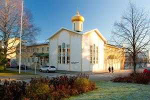 a large white building with a gold dome on top at Hotel Golden Dome Iisalmi in Iisalmi